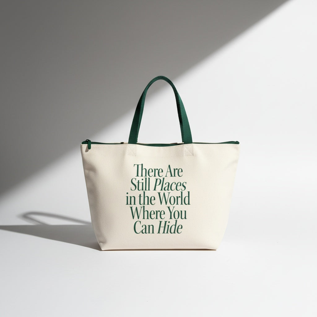 Beige tote bag with green text and handles on a light gray background