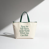 Beige tote bag with green text and handles on a light gray background